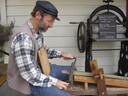 A villager working with some wood.